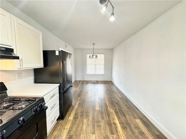 kitchen with hanging light fixtures, white cabinetry, dark wood-type flooring, and black appliances