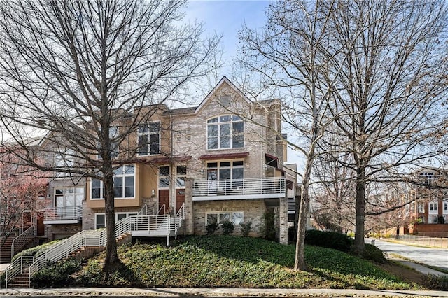 view of property with stairway and a front yard