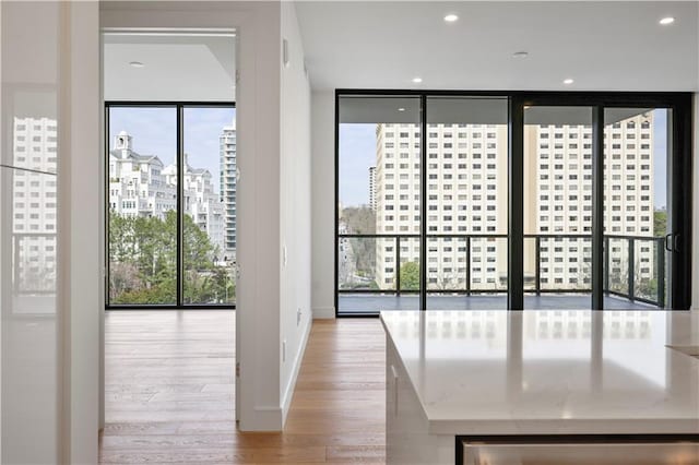 2425 Peachtree Rd NE Unit 903, Atlanta, GA 30305 - spare room with wood finished floors, healthy amount of natural light, a view of city, floor to ceiling windows, and recessed lighting
