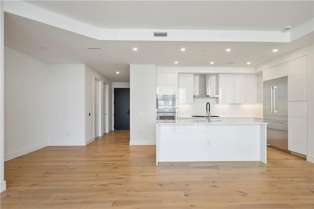 kitchen with visible vents, light wood-style flooring, white cabinetry, and modern cabinets