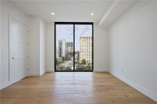 2425 Peachtree Rd NE Unit 903, Atlanta, GA 30305 - unfurnished room with floor to ceiling windows, wood finished floors, and recessed lighting