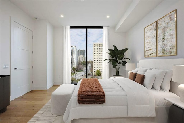 2425 Peachtree Rd NE Unit 903, Atlanta, GA 30305 - bedroom featuring light wood-style flooring, expansive windows, access to outside, and recessed lighting
