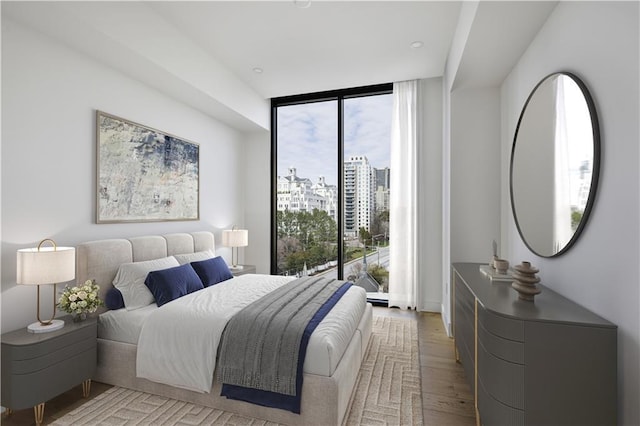2425 Peachtree Rd NE Unit 903, Atlanta, GA 30305 - bedroom with multiple windows, floor to ceiling windows, light wood-type flooring, and a view of city