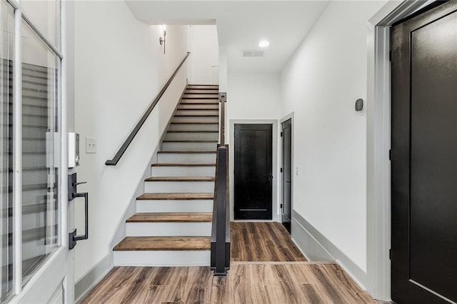 stairs with wood-type flooring