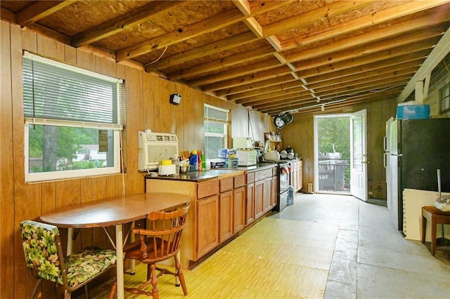 kitchen featuring white appliances, brown cabinetry, wood walls, and dark countertops