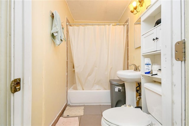 bathroom featuring toilet, tile patterned flooring, and shower / bath combo