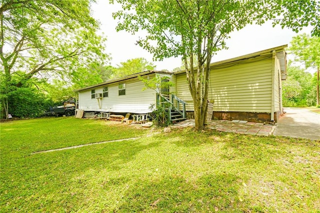 rear view of property featuring a lawn