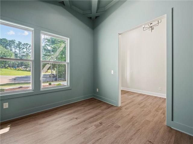 2335 Azalea Dr, Loganville, GA 30052 - spare room featuring light wood-style flooring, coffered ceiling, crown molding, and beam ceiling