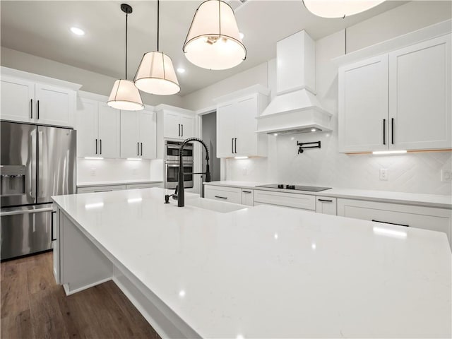 2335 Azalea Dr, Loganville, GA 30052 - kitchen with stainless steel fridge with ice dispenser, premium range hood, black electric cooktop, white cabinetry, and recessed lighting