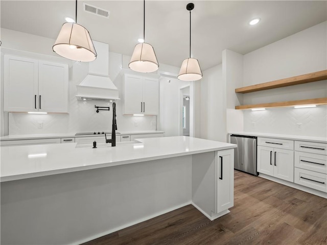 2335 Azalea Dr, Loganville, GA 30052 - kitchen with stainless steel dishwasher, dark wood-style floors, backsplash, white cabinets, and light countertops