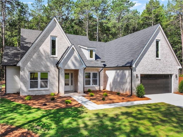 2335 Azalea Dr, Loganville, GA 30052 - view of front of home with driveway, an attached garage, brick siding, a front yard, and roof with shingles