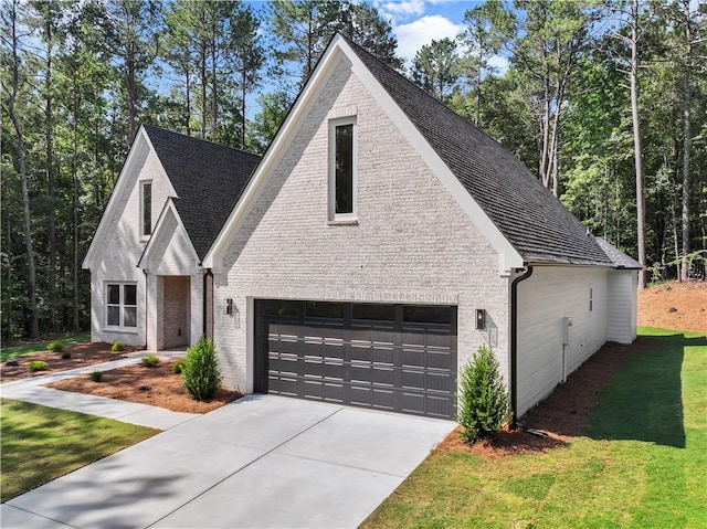 2335 Azalea Dr, Loganville, GA 30052 - view of front of property featuring brick siding, driveway, an attached garage, and a front yard