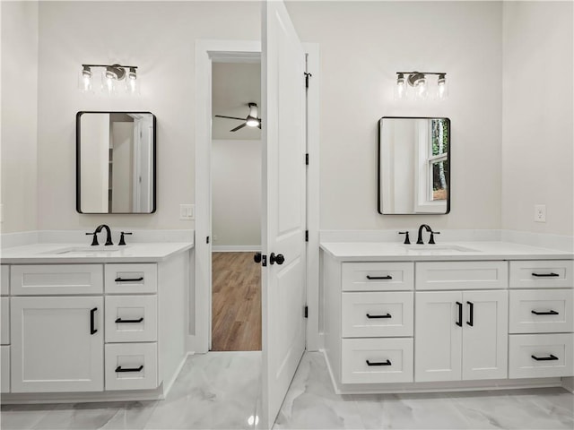 2335 Azalea Dr, Loganville, GA 30052 - full bathroom with marble look tiles, two vanities, and ceiling fan