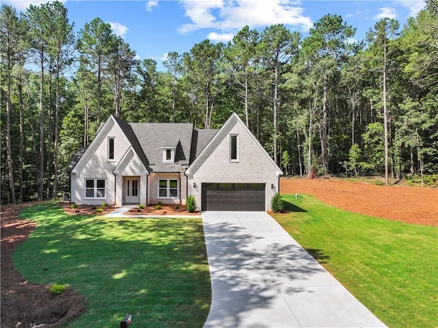 2335 Azalea Dr, Loganville, GA 30052 - modern farmhouse with a garage, concrete driveway, a front yard, brick siding, and a view of trees