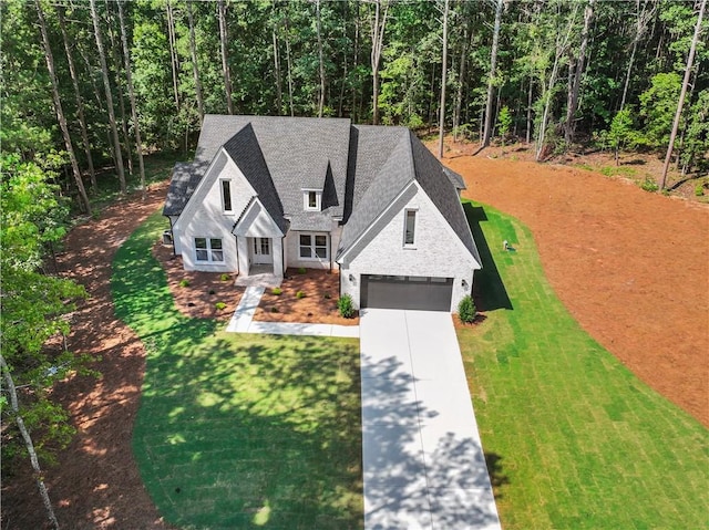 2335 Azalea Dr, Loganville, GA 30052 - view of front facade featuring driveway, roof with shingles, a front lawn, and a forest view