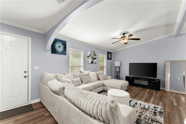 living room featuring dark hardwood / wood-style floors, ceiling fan, and ornamental molding