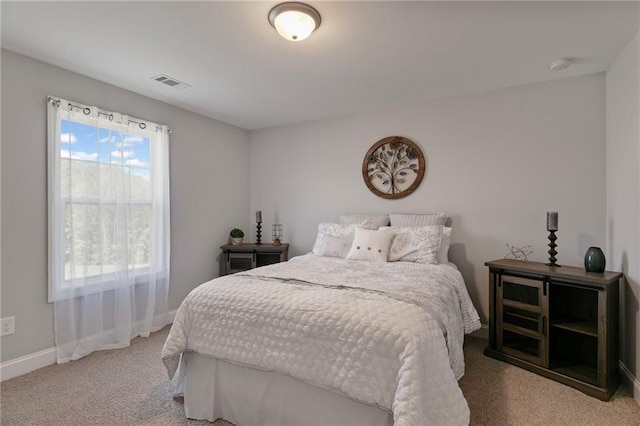 bedroom with carpet floors, visible vents, and baseboards