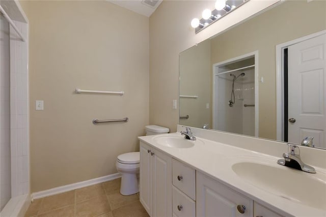 8020 Woodland Ln, Alpharetta, GA 30009 - bathroom with a tile shower, toilet, double vanity, tile patterned flooring, and baseboards