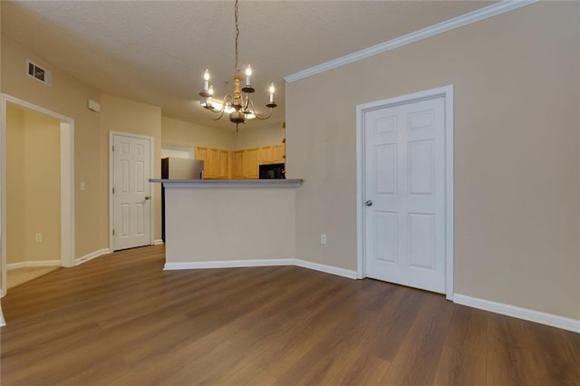 8020 Woodland Ln, Alpharetta, GA 30009 - kitchen featuring a chandelier, baseboards, wood finished floors, a textured ceiling, and crown molding