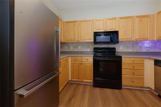 8020 Woodland Ln, Alpharetta, GA 30009 - kitchen featuring black appliances, light brown cabinetry, and wood finished floors