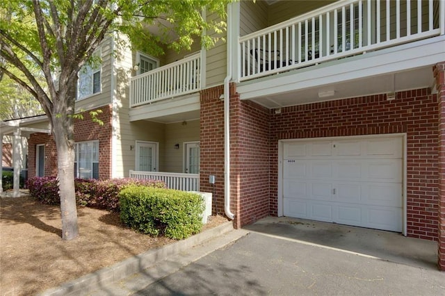 8020 Woodland Ln, Alpharetta, GA 30009 - view of side of home with brick siding, an attached garage, and asphalt driveway