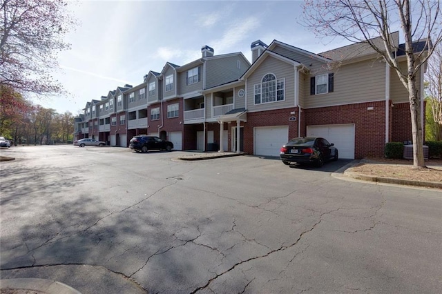 8020 Woodland Ln, Alpharetta, GA 30009 - view of asphalt road featuring a residential view and curbs