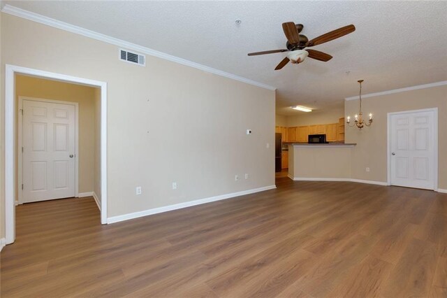 8020 Woodland Ln, Alpharetta, GA 30009 - unfurnished living room featuring a chandelier, ceiling fan, wood finished floors, crown molding, and baseboards
