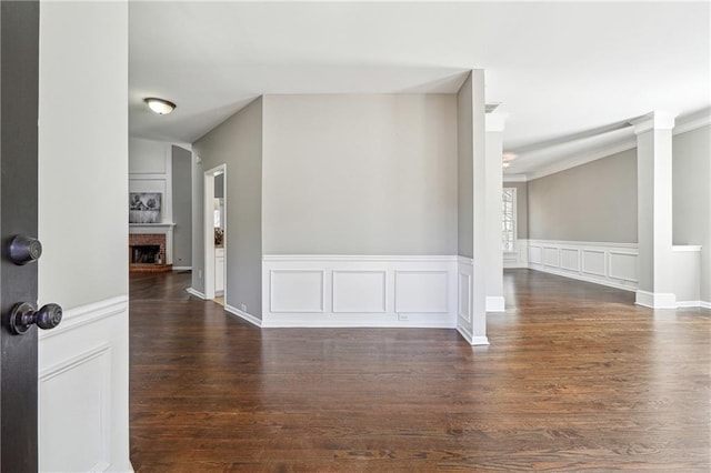 interior space with a fireplace, wood finished floors, and a decorative wall