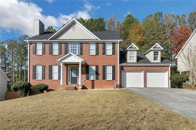 colonial inspired home with a front lawn