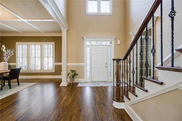 entrance foyer with ornate columns, stairs, baseboards, and dark wood finished floors