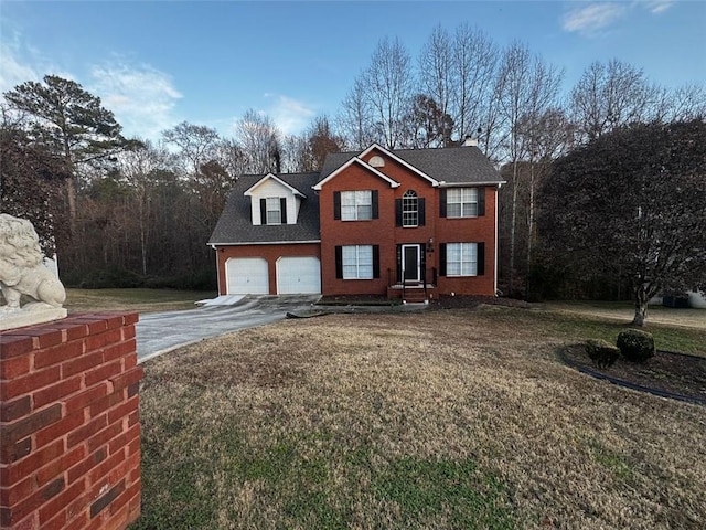 view of front of property featuring a front lawn and a garage