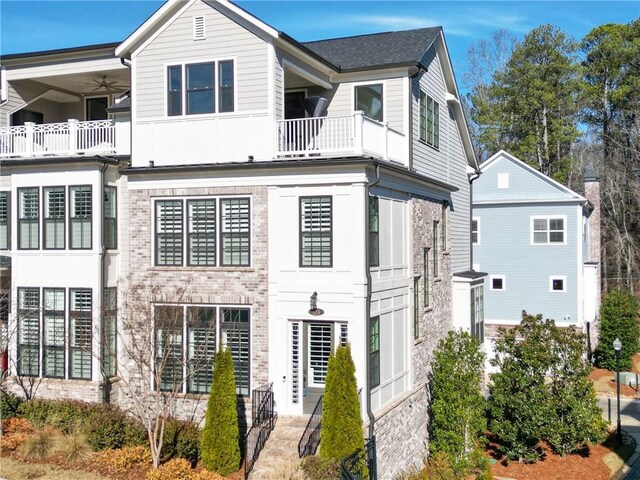 multi unit property with a balcony and ceiling fan