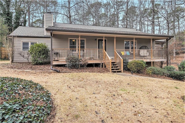 view of front of property with a chimney, stairway, roof with shingles, a porch, and a front yard