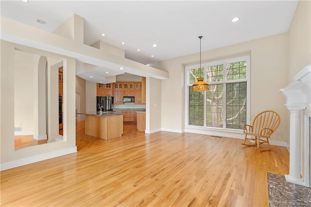 267 Starcross Ln, Jasper, GA 30143 - unfurnished living room with light wood finished floors, baseboards, recessed lighting, a high end fireplace, and arched walkways
