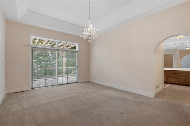 267 Starcross Ln, Jasper, GA 30143 - empty room with light carpet, a chandelier, arched walkways, and baseboards