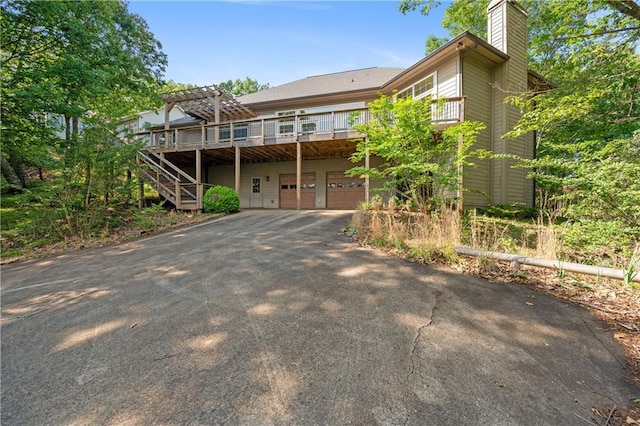 267 Starcross Ln, Jasper, GA 30143 - view of front of house with a chimney, asphalt driveway, an attached garage, a pergola, and stairs