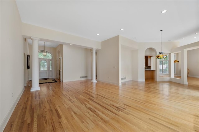 267 Starcross Ln, Jasper, GA 30143 - unfurnished living room featuring light wood finished floors, recessed lighting, baseboards, a chandelier, and arched walkways