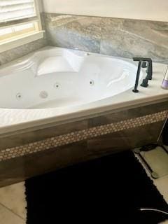 bathroom featuring tiled bath and tile patterned floors