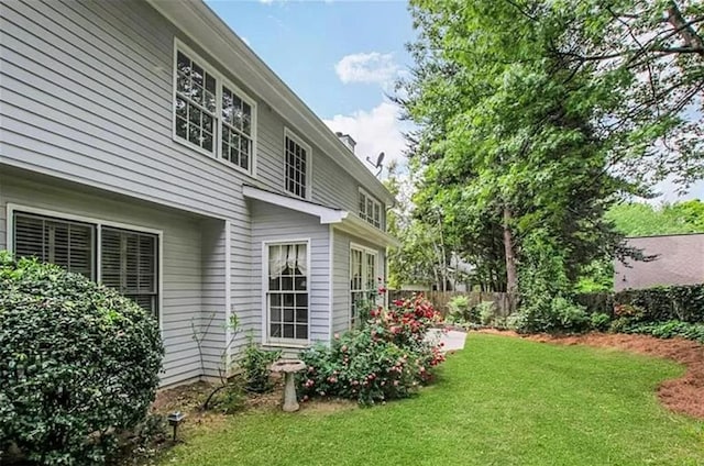 exterior space featuring fence and a yard