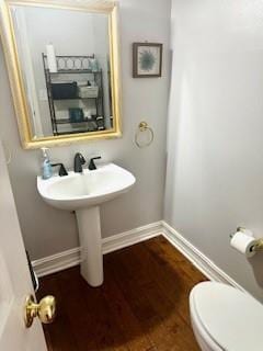 bathroom featuring toilet and hardwood / wood-style flooring