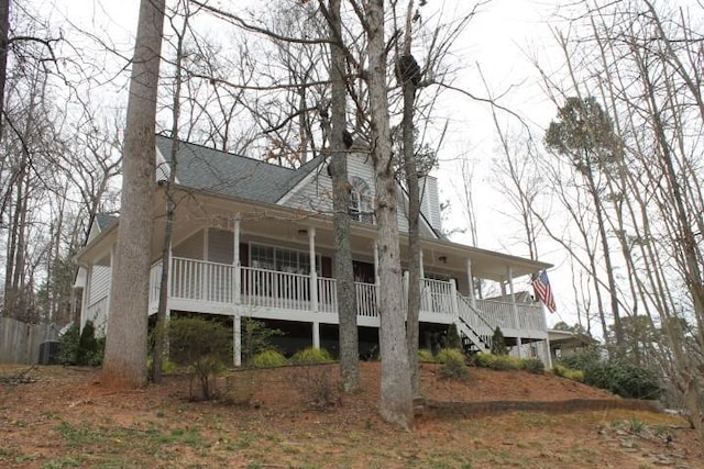 exterior space with a porch, a chimney, and stairs