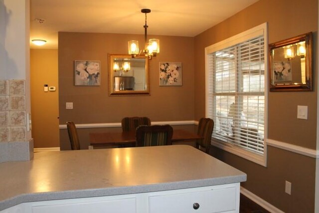 dining area featuring a ceiling fan, crown molding, and wood finished floors