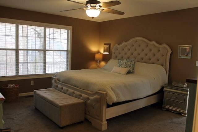 bedroom featuring baseboards, carpet floors, and a ceiling fan