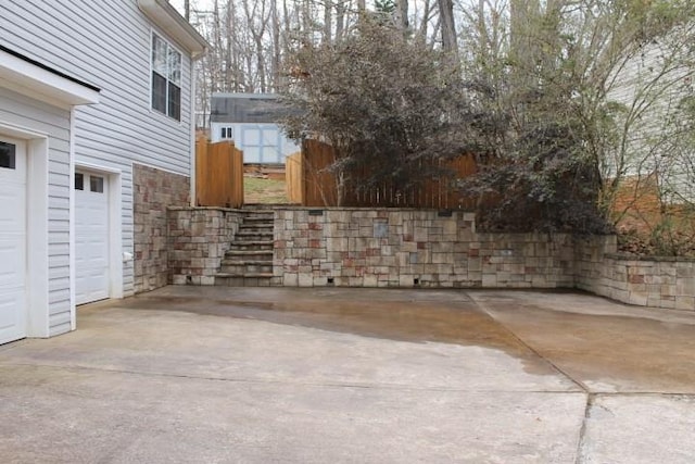 view of patio with a garage and stairs