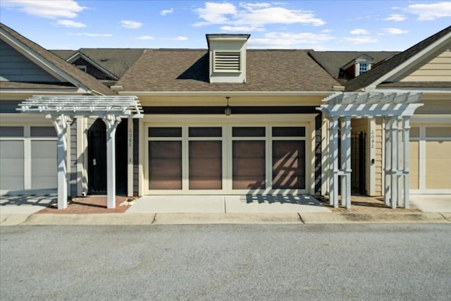 view of front of property with a pergola and roof with shingles