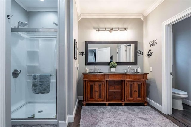 bathroom with vanity, toilet, wood-type flooring, and a shower with shower door