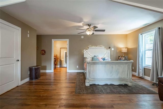 unfurnished bedroom featuring ceiling fan and dark hardwood / wood-style flooring