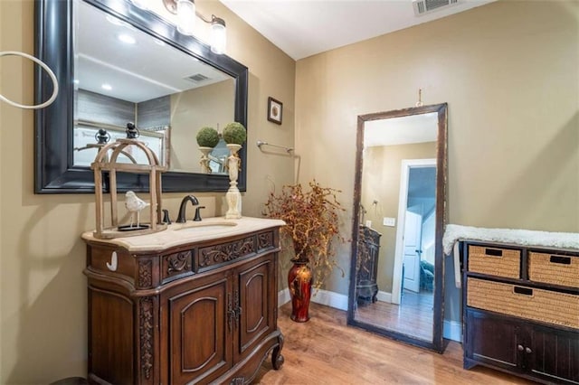 bathroom featuring vanity and wood-type flooring