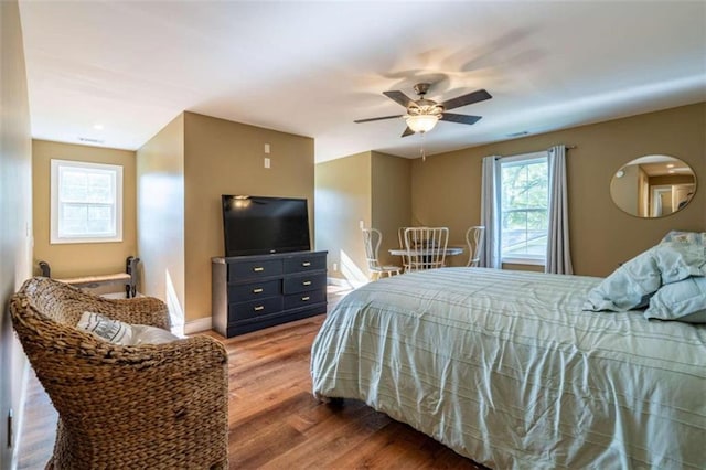 bedroom with ceiling fan and hardwood / wood-style flooring