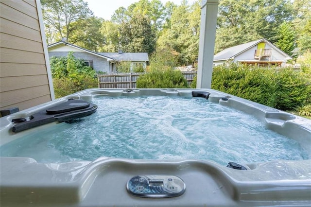 view of pool with a hot tub